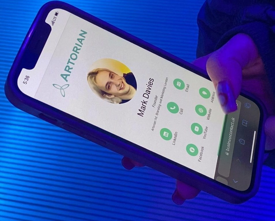 A phone showing an Artorian mini website with contact buttons